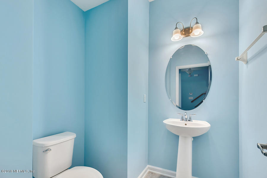 122 Nelson Lane St. Johns, FL 32259 - Photo 11 of 33 a bathroom with a toilet sink and mirror