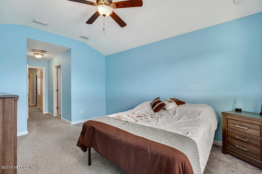 122 Nelson Lane St. Johns, FL 32259 - Photo 17 of 33 a bedroom with a bed and cabinets