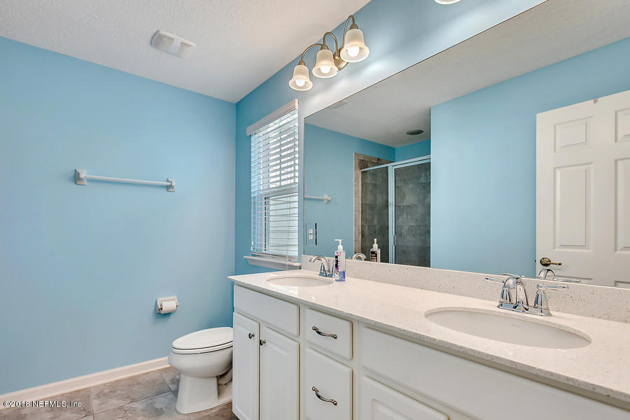 122 Nelson Lane St. Johns, FL 32259 - Photo 18 of 33 a bathroom with a double vanity sink toilet and a mirror