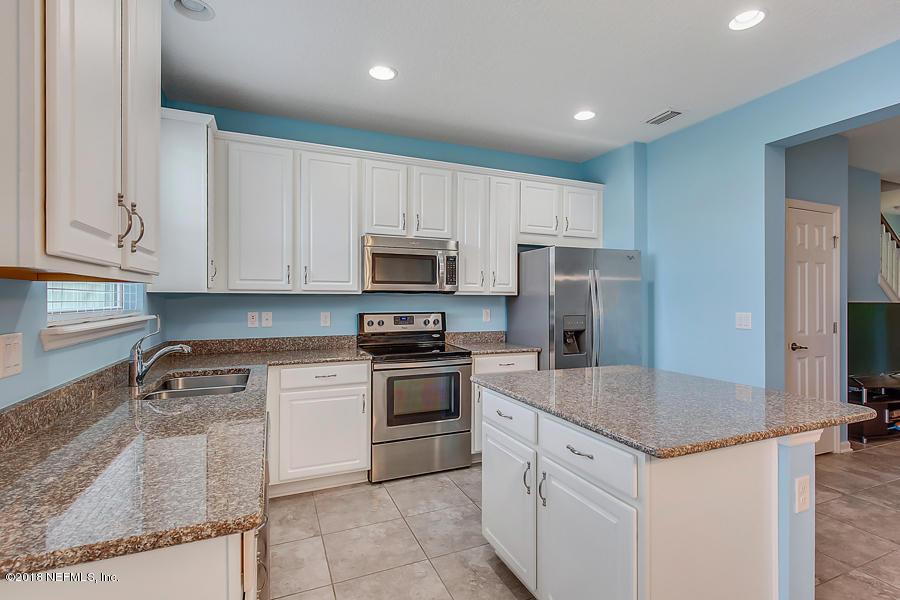122 Nelson Lane St. Johns, FL 32259 - Photo 8 of 33 a kitchen with stainless steel appliances granite countertop a sink stove and refrigerator