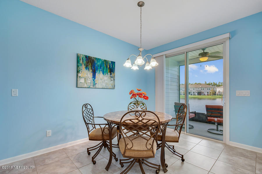 122 Nelson Lane St. Johns, FL 32259 - Photo 10 of 33 a dining room with furniture a chandelier and window