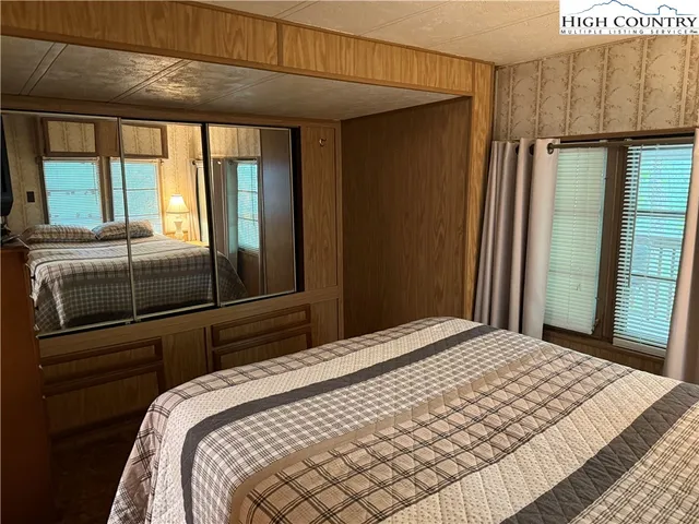 a bedroom with a bed and a mirror