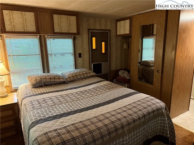 a bedroom with a bed and a mirror