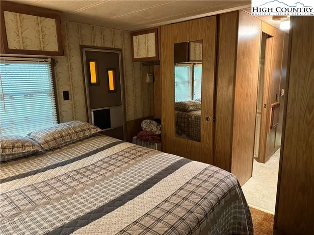 a bedroom with a bed and a mirror