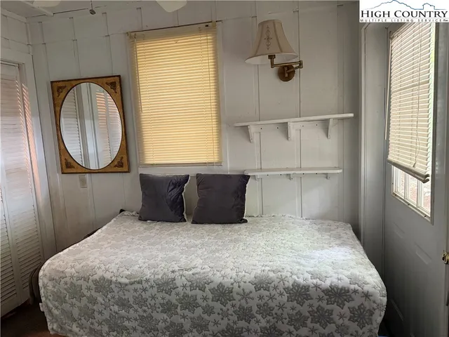 a bedroom with a bed and window