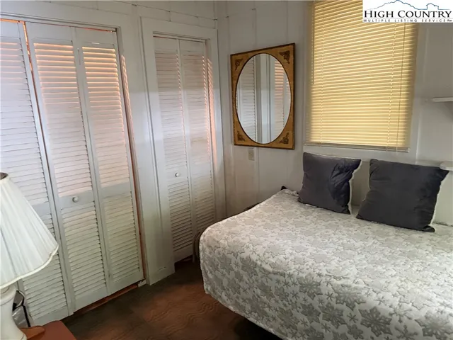 a bedroom with a bed and a mirror