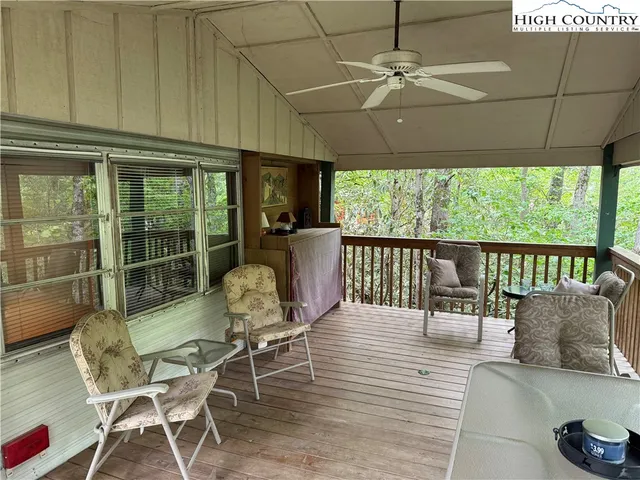a dining room with furniture a chandelier and wooden floor