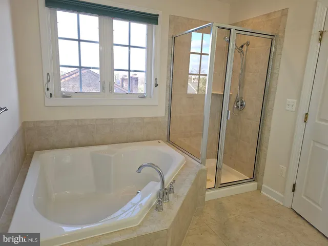 a bathroom with a tub and shower