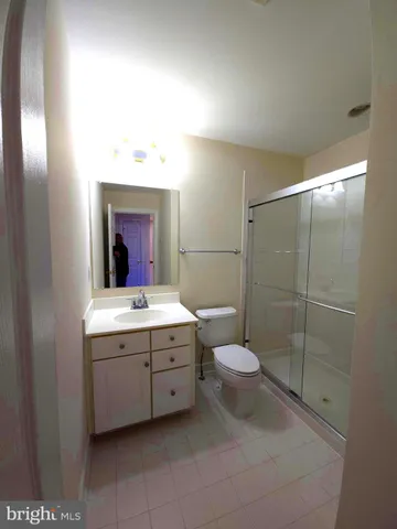 a bathroom with a double vanity sink mirror and toilet