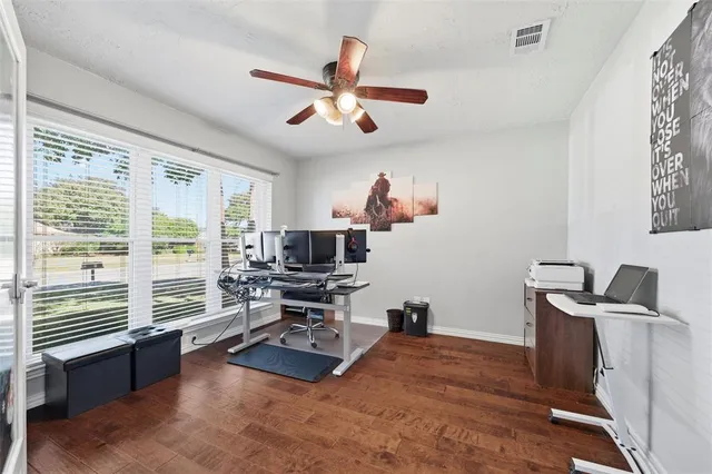 a view of a workspace with furniture and a window