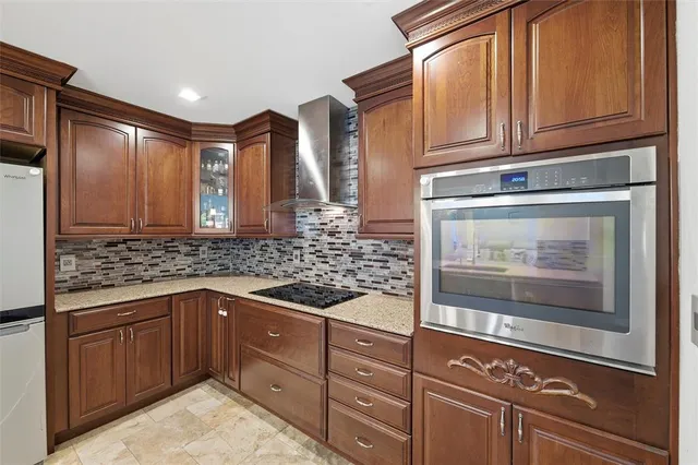 a kitchen with stainless steel appliances granite countertop a stove and a sink
