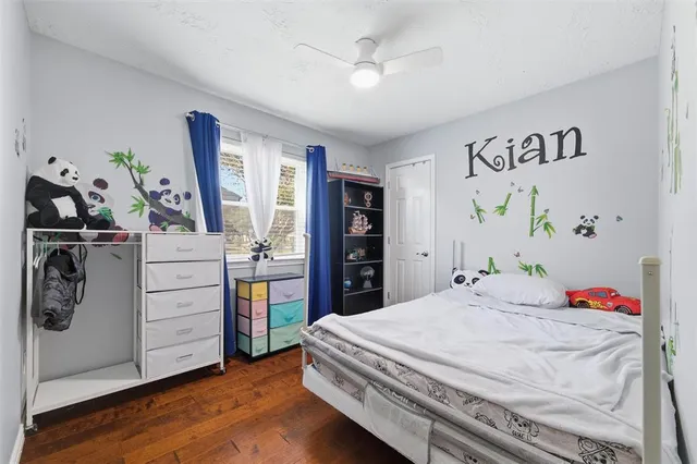 a bathroom with a granite countertop toilet sink and mirror