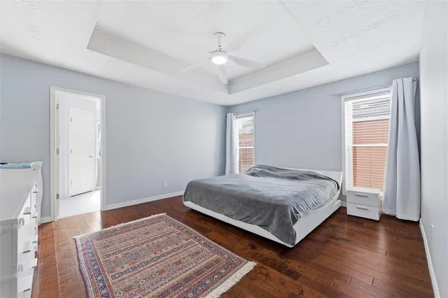 a spacious bedroom with a bed and a dresser