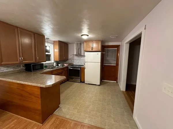a kitchen with a sink a stove and refrigerator