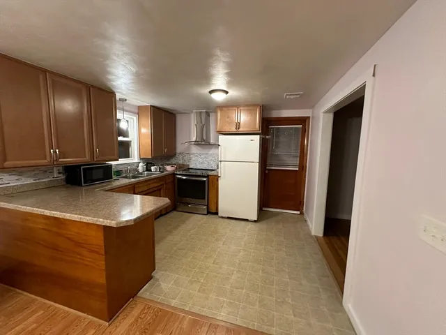 a kitchen with a sink a stove and refrigerator