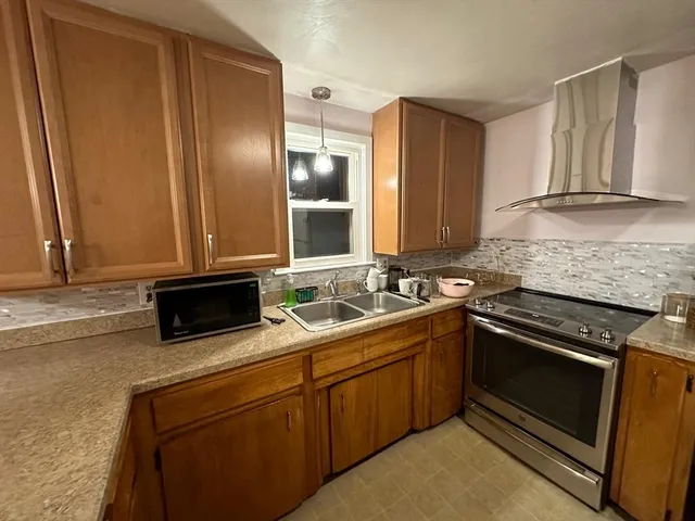 a kitchen that has a sink and a stove