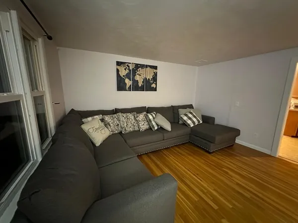 a living room with a couch and a window