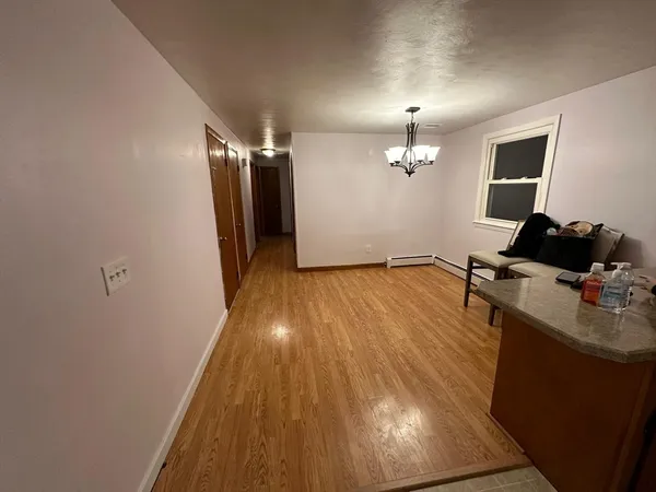 a view of a room with wooden floor and staircase