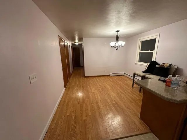 a view of a room with wooden floor and staircase