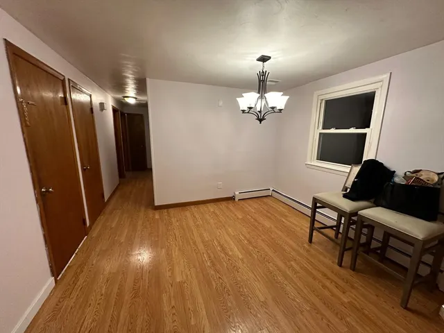a view of hallway with wooden floor