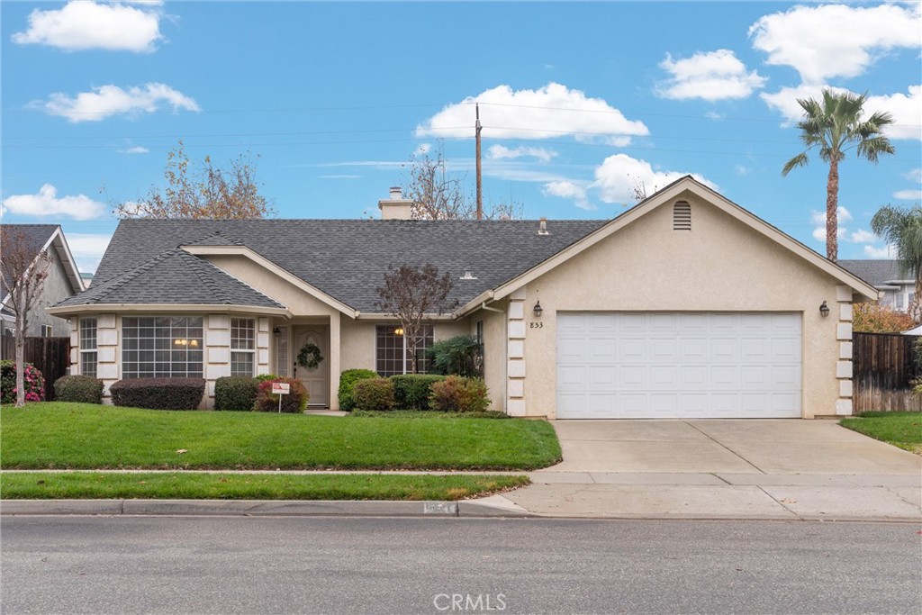 853 Coit Tower Way Chico, CA 95928 - Photo 11 of 49 a front view of a house with a yard and garage