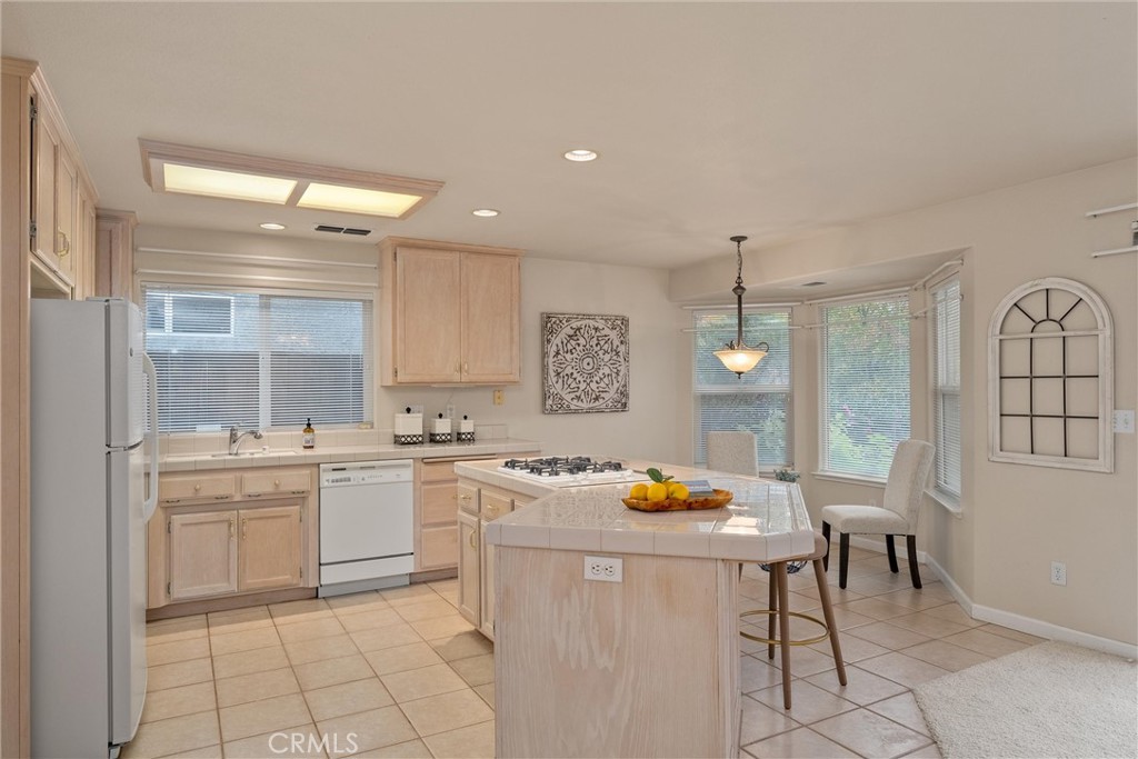 853 Coit Tower Way Chico, CA 95928 - Photo 22 of 49 a kitchen with a sink chairs and cabinets