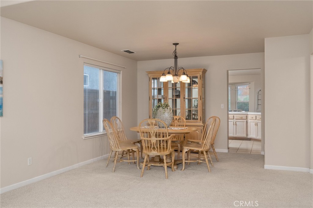 853 Coit Tower Way Chico, CA 95928 - Photo 26 of 49 a view of a dining room with furniture window and chandelier