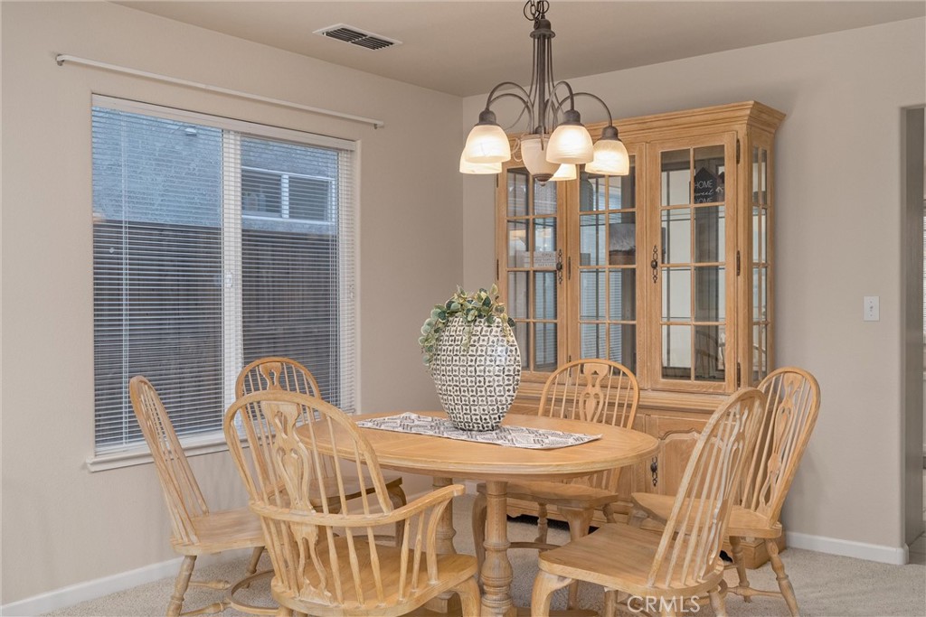 853 Coit Tower Way Chico, CA 95928 - Photo 27 of 49 a view of a dining room with furniture window and outside view
