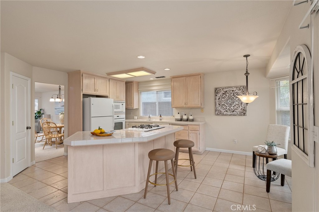 853 Coit Tower Way Chico, CA 95928 - Photo 3 of 49 a kitchen with a dining table chairs and cabinets
