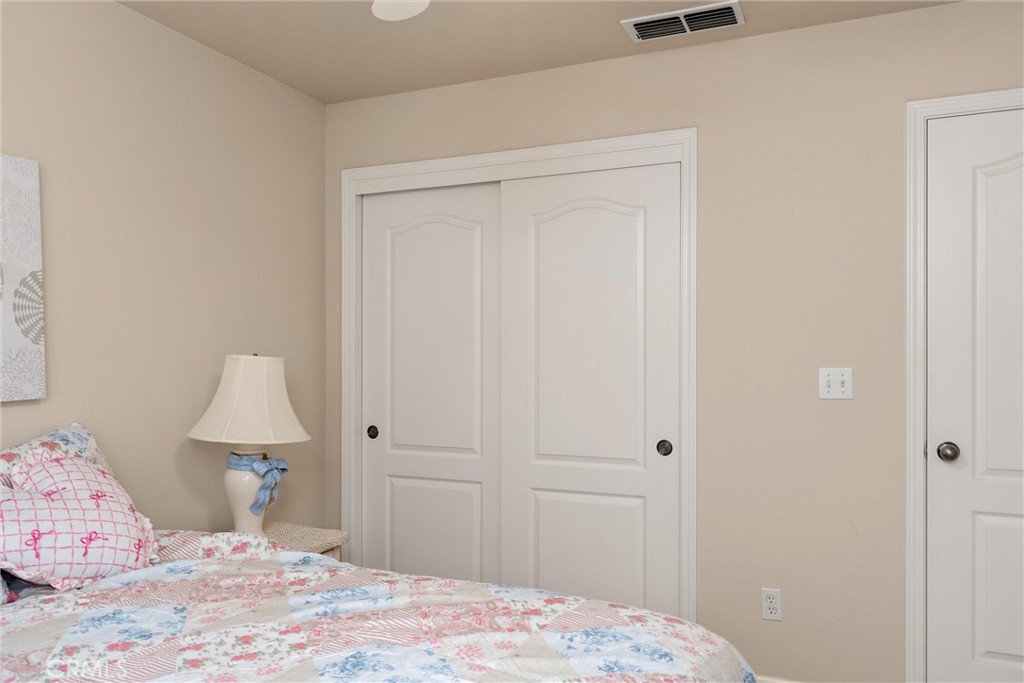 853 Coit Tower Way Chico, CA 95928 - Photo 33 of 49 a bedroom with a bed and a lamp