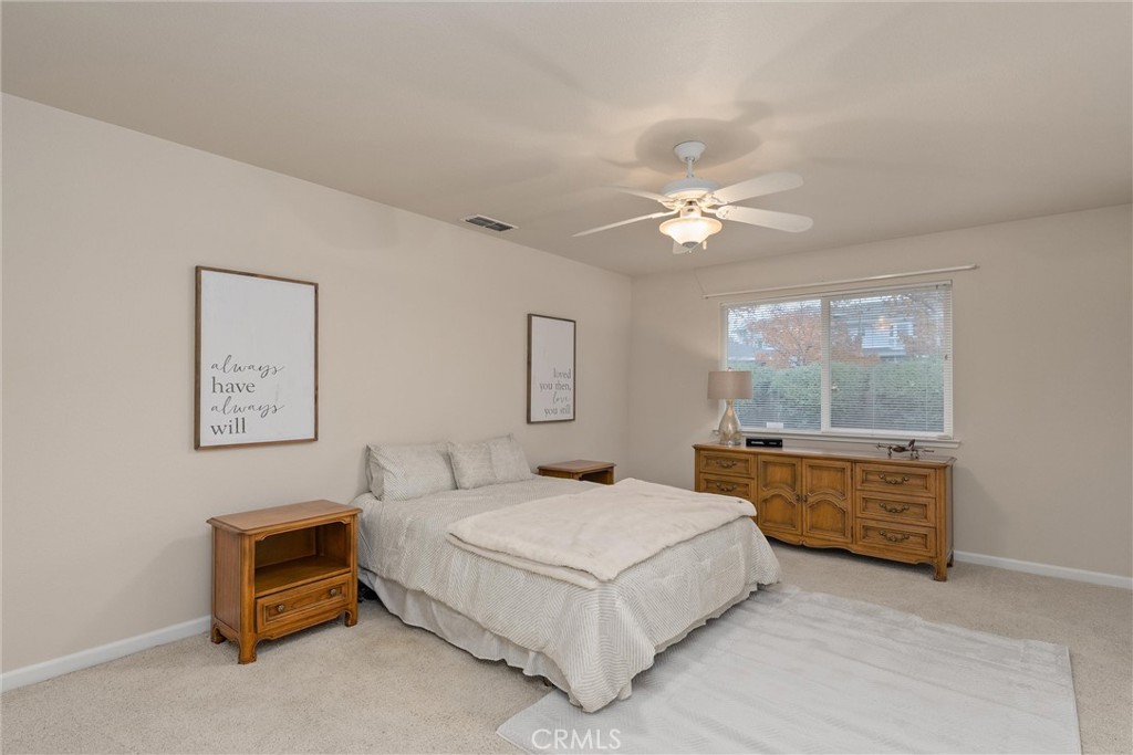 853 Coit Tower Way Chico, CA 95928 - Photo 35 of 49 a bedroom with a bed and a chandelier