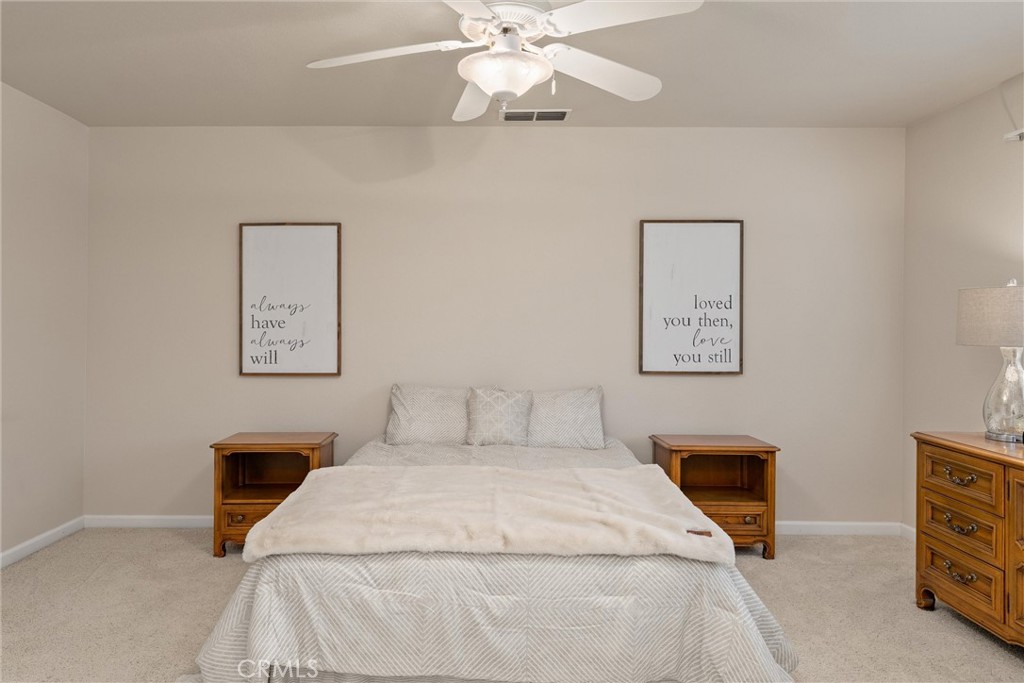 853 Coit Tower Way Chico, CA 95928 - Photo 36 of 49 a bedroom with a bed and a chandelier
