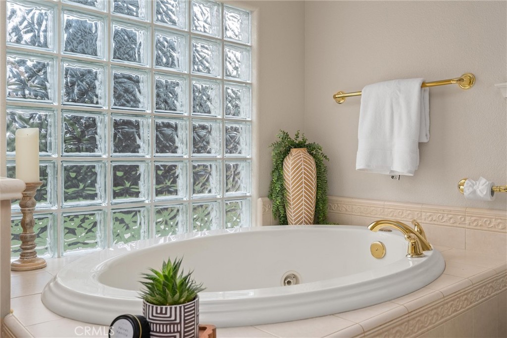 853 Coit Tower Way Chico, CA 95928 - Photo 40 of 49 a bathroom with a tub and a potted plant
