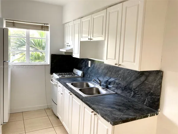 a kitchen with a sink and cabinets