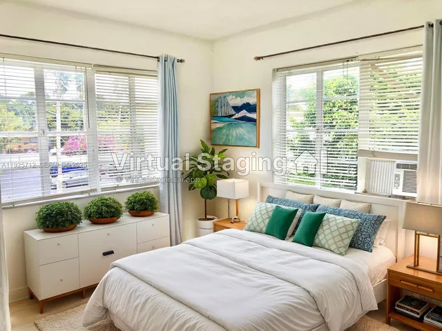 a bedroom with a bed chair and window