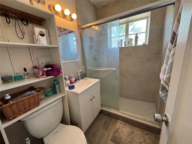 a bathroom with a toilet sink and shower