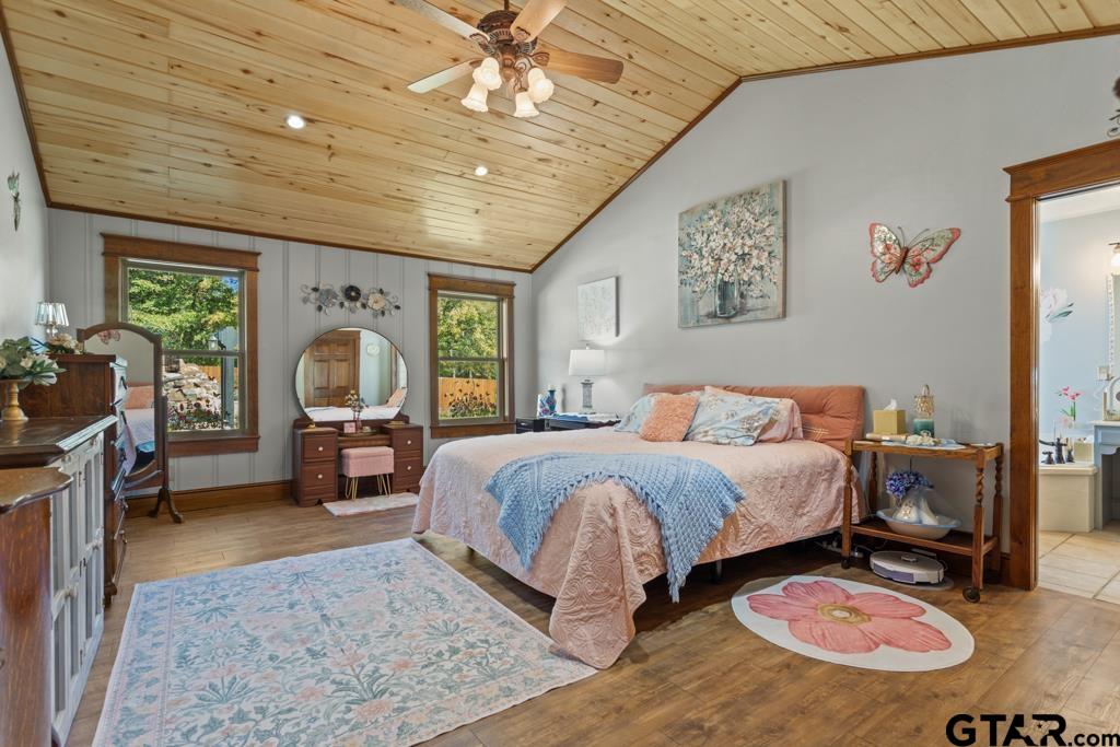 10433 County Road 334 Tyler, TX 75708 - Photo 15 of 43 a spacious bedroom with a bed a chandelier and dresser