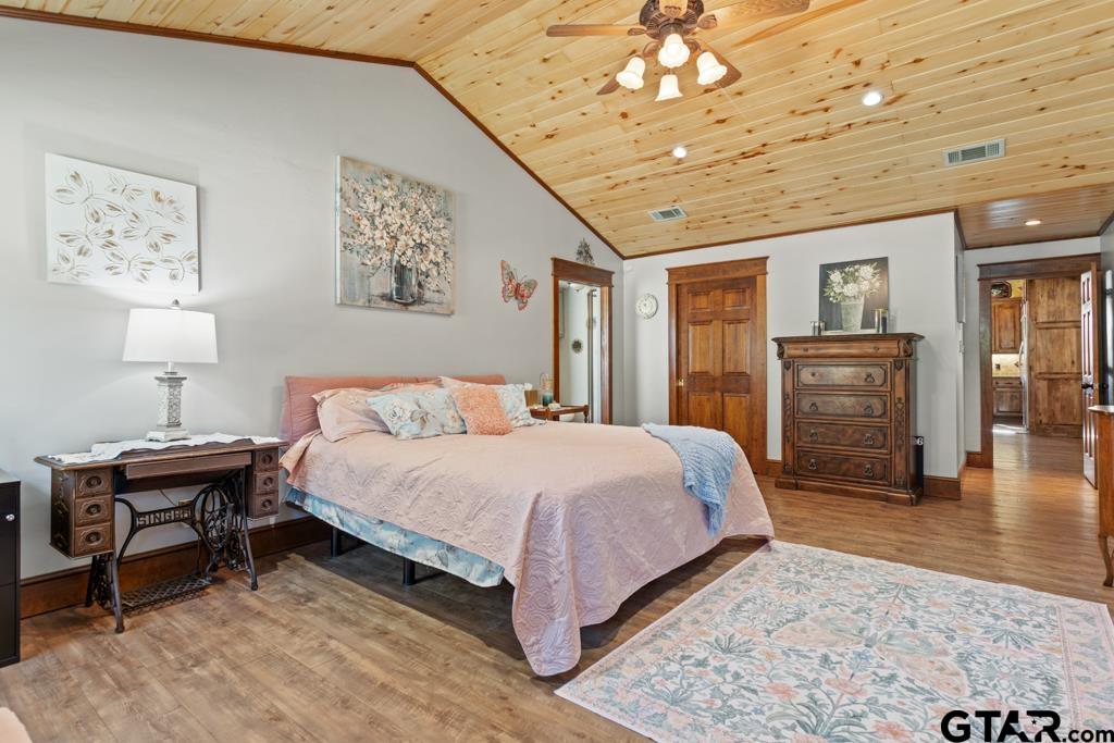 10433 County Road 334 Tyler, TX 75708 - Photo 16 of 43 a bedroom with a bed and wooden floor