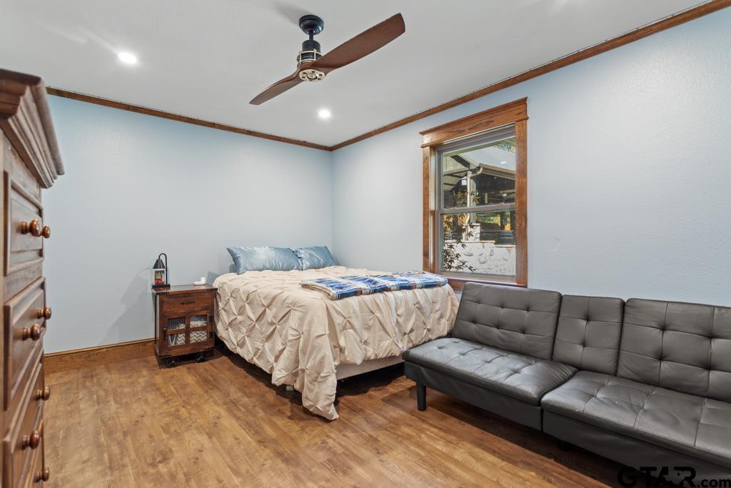 10433 County Road 334 Tyler, TX 75708 - Photo 19 of 43 a bedroom with a bed couch and window