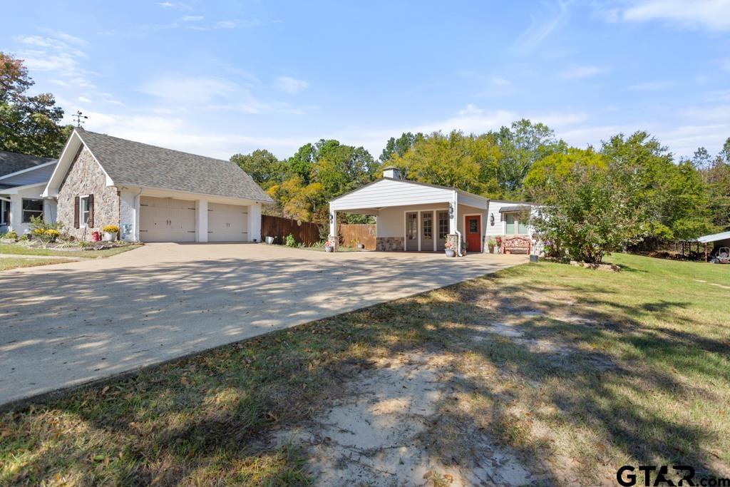 10433 County Road 334 Tyler, TX 75708 - Photo 29 of 43 a front view of a house with a yard and trees