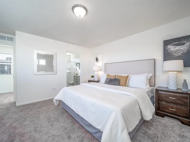 a bed room with a bed and a night stand