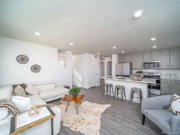 a living room with kitchen island furniture and a wooden floor