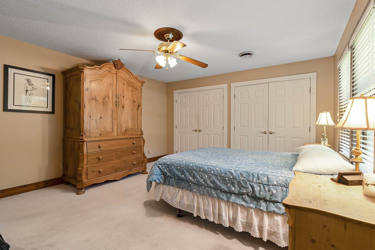 3109 Barnsley Lane Raleigh, NC 27604 - Photo 14 of 50 a bedroom with a bed and a chandelier