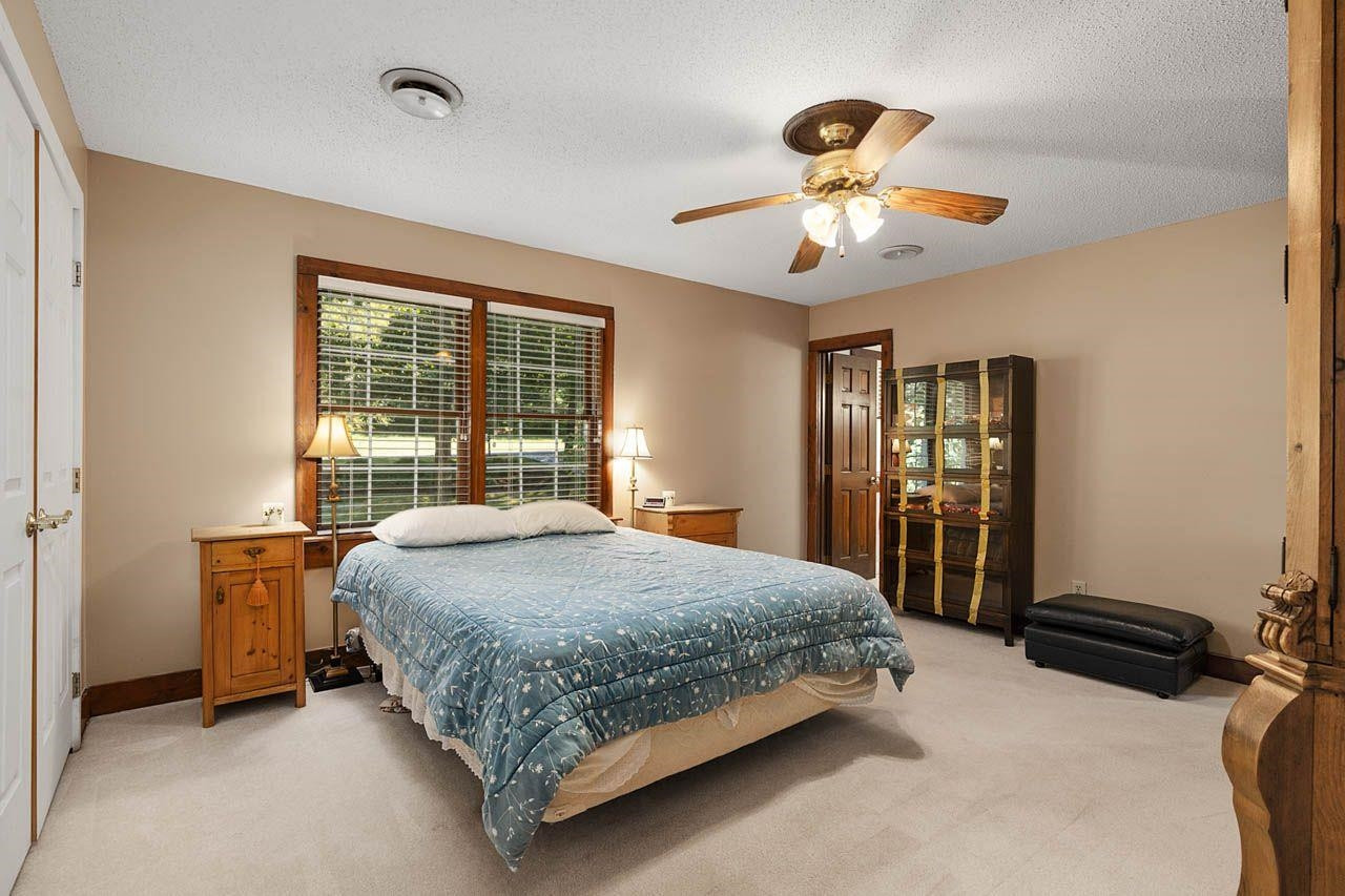 3109 Barnsley Lane Raleigh, NC 27604 - Photo 15 of 50 a bedroom with a bed and large windows