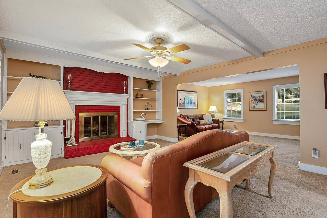 3109 Barnsley Lane Raleigh, NC 27604 - Photo 21 of 50 a living room with fireplace a table and a fireplace