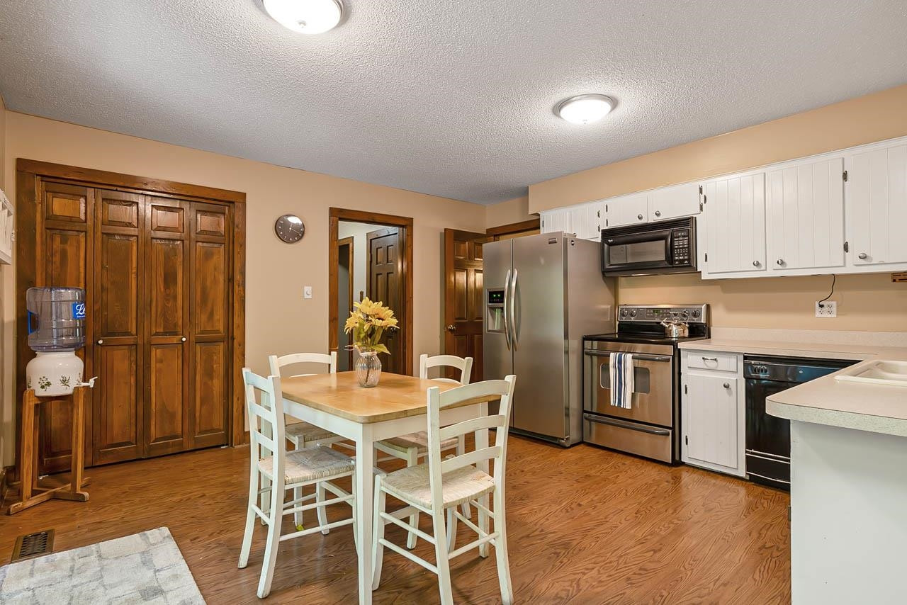 3109 Barnsley Lane Raleigh, NC 27604 - Photo 25 of 50 a kitchen with granite countertop a refrigerator stove top oven and sink
