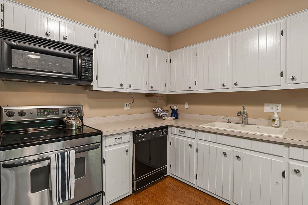 3109 Barnsley Lane Raleigh, NC 27604 - Photo 27 of 50 a kitchen with granite countertop white cabinets and stainless steel appliances