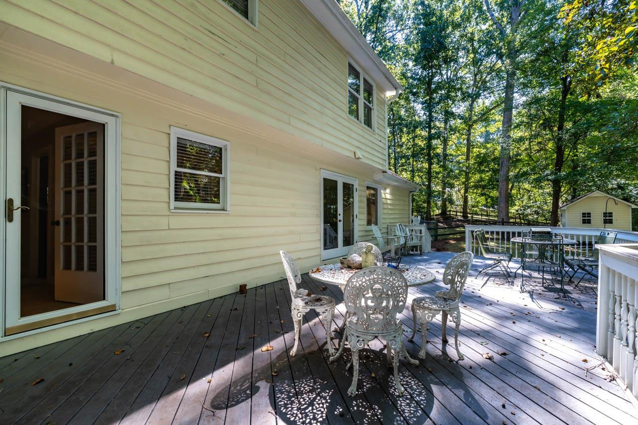 3109 Barnsley Lane Raleigh, NC 27604 - Photo 36 of 50 a view of a patio with table and chairs and wooden floor