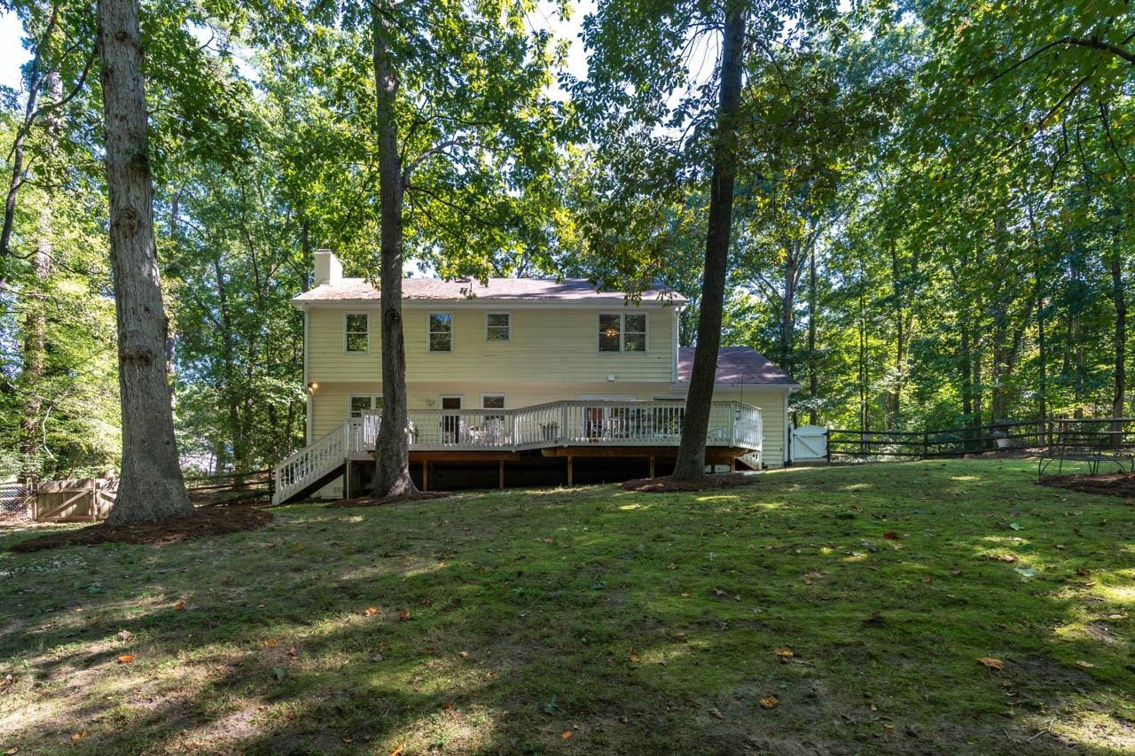 3109 Barnsley Lane Raleigh, NC 27604 - Photo 39 of 50 a view of a house with a big yard and large trees
