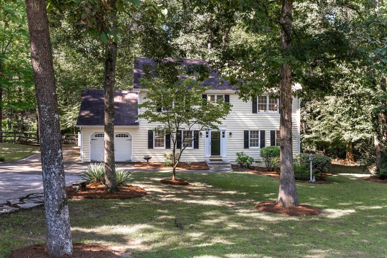 3109 Barnsley Lane Raleigh, NC 27604 - Photo 40 of 50 a front view of a house with a yard fountain and tree s